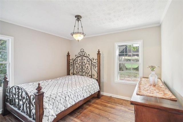 bedroom with crown molding and dark hardwood / wood-style flooring