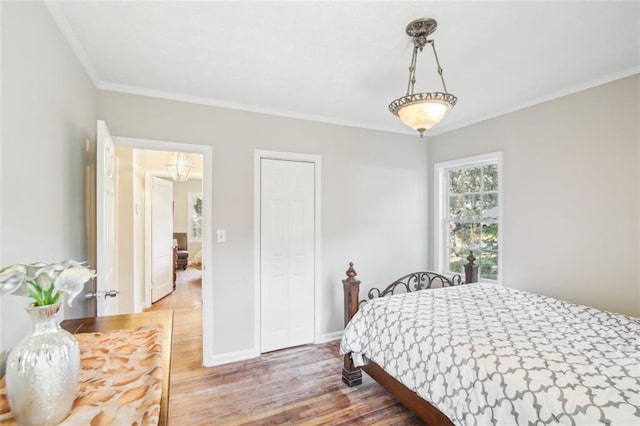 bedroom featuring crown molding and wood-type flooring