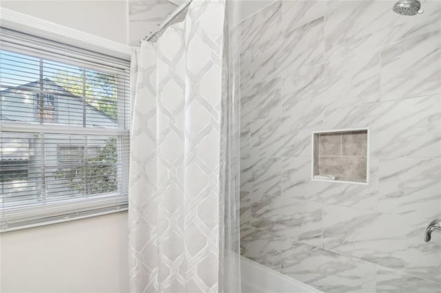 bathroom with shower / bath combination with curtain