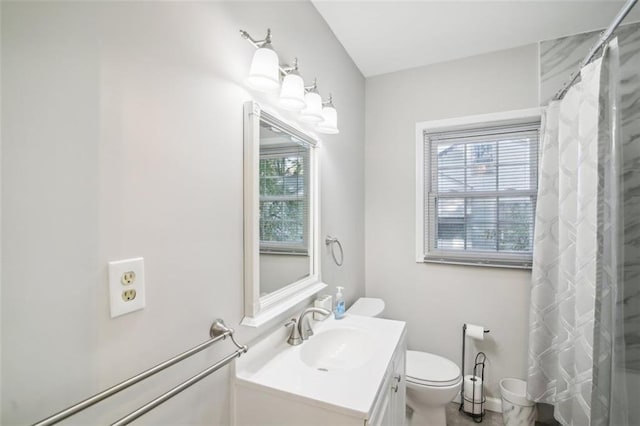 bathroom featuring vanity, curtained shower, and toilet