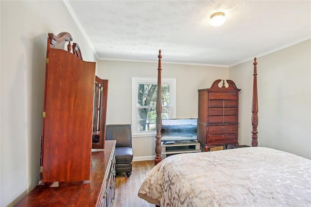 bedroom with ornamental molding, a textured ceiling, and dark hardwood / wood-style floors