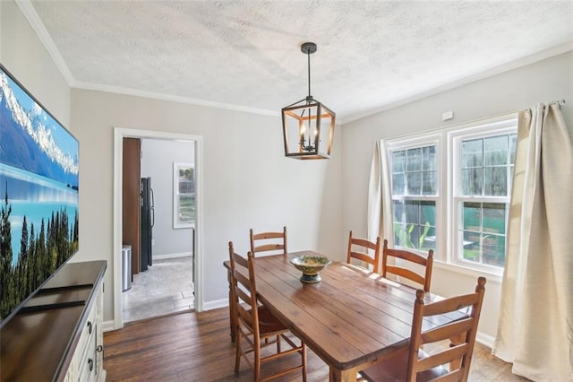 dining area featuring ornamental molding, an inviting chandelier, a textured ceiling, and dark hardwood / wood-style flooring