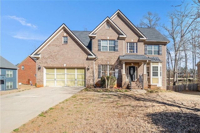 view of front of home featuring driveway, a garage, fence, and brick siding