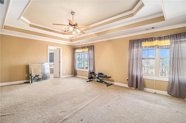 carpeted spare room with ceiling fan, baseboards, visible vents, and a raised ceiling