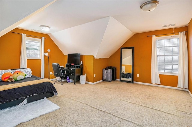 carpeted bedroom featuring visible vents, vaulted ceiling, baseboards, and multiple windows