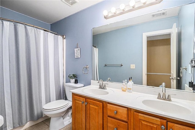 bathroom featuring visible vents, a sink, and tile patterned floors