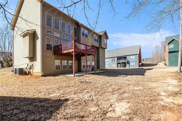 rear view of house featuring a patio area, a deck, and central air condition unit