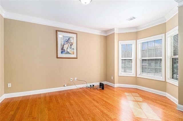 unfurnished room with light wood-type flooring, plenty of natural light, visible vents, and baseboards