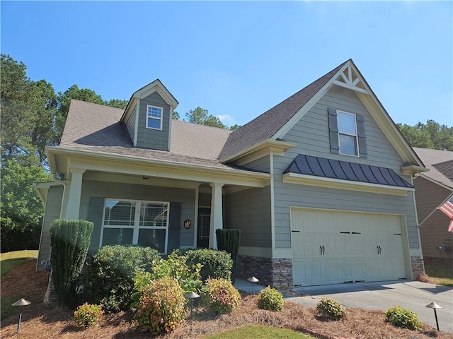 view of front facade featuring a garage and covered porch