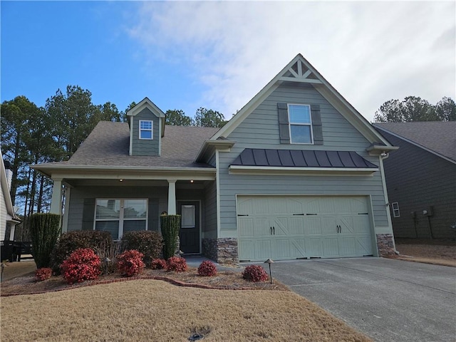 view of front facade featuring a garage, covered porch, and a front lawn