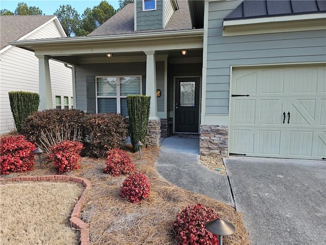 entrance to property featuring a garage and a porch