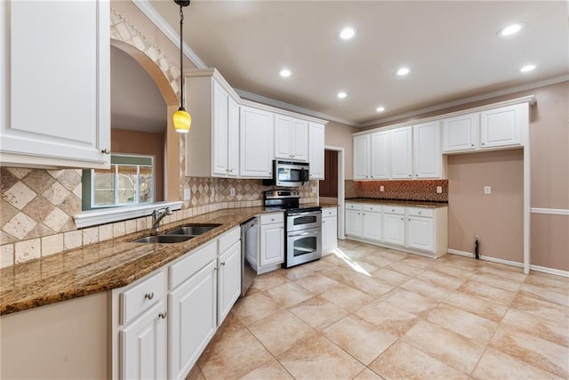 kitchen with sink, white cabinetry, decorative light fixtures, dark stone counters, and stainless steel appliances