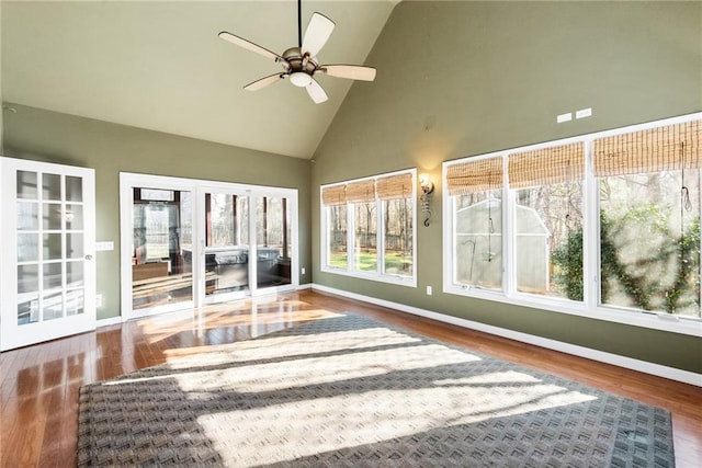 unfurnished sunroom featuring ceiling fan and vaulted ceiling