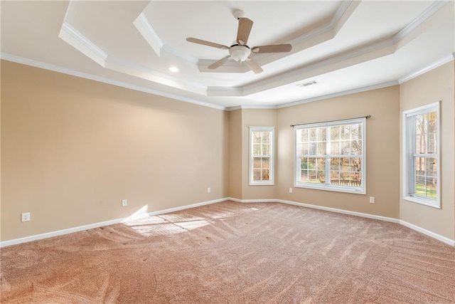 empty room with light carpet, crown molding, a raised ceiling, and ceiling fan