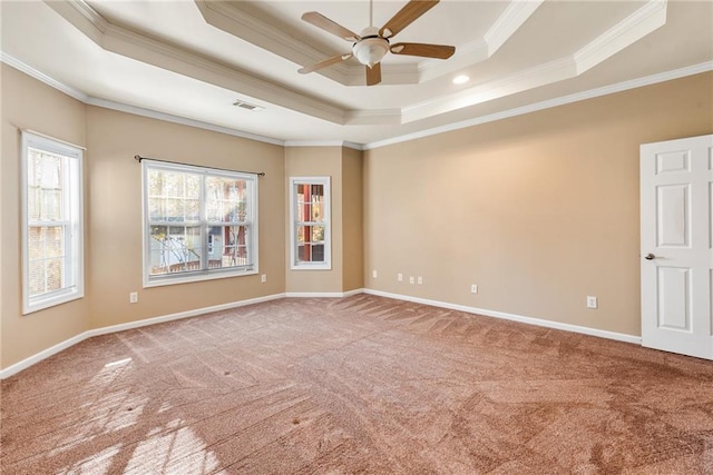 unfurnished room with ornamental molding, carpet flooring, ceiling fan, and a tray ceiling