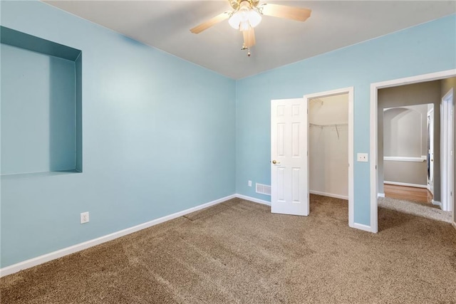 unfurnished bedroom featuring carpet floors, ceiling fan, and a closet