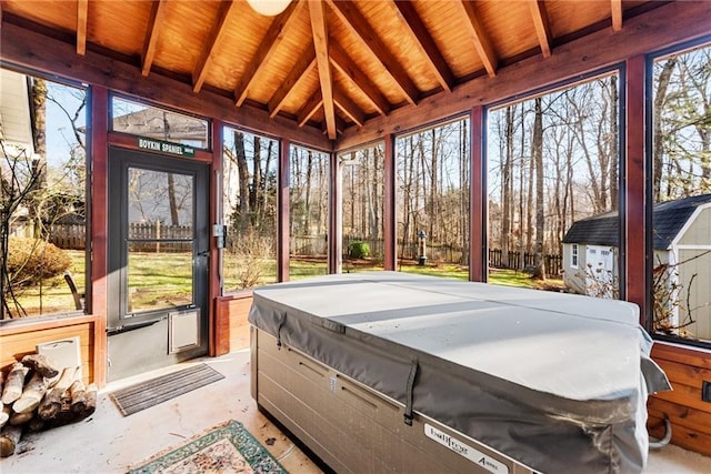 sunroom featuring beamed ceiling, a jacuzzi, and wooden ceiling