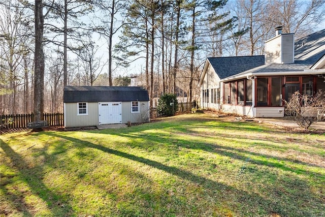 view of yard with a storage shed, a patio, and a sunroom