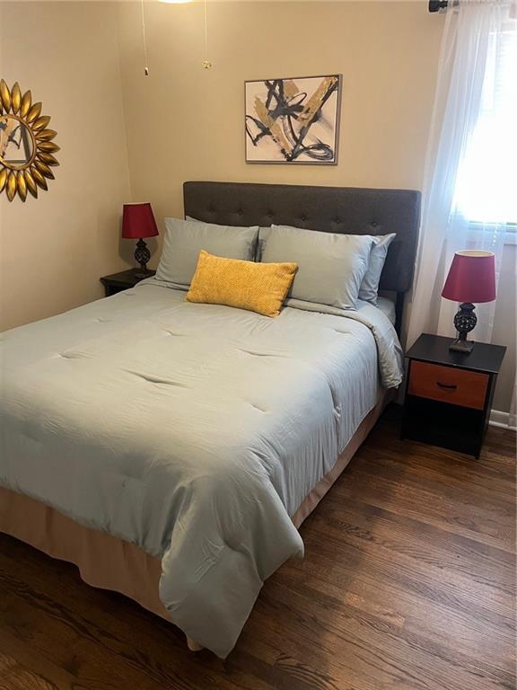 bedroom with wood finished floors