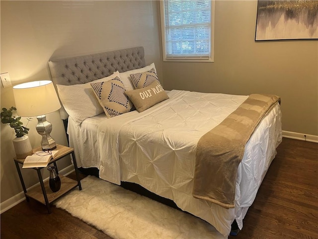 bedroom with wood finished floors and baseboards