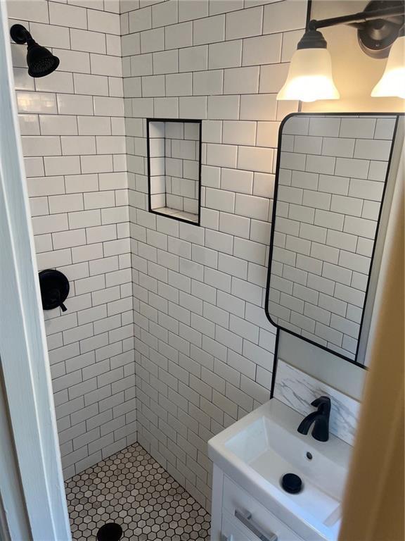 bathroom featuring a shower stall and vanity