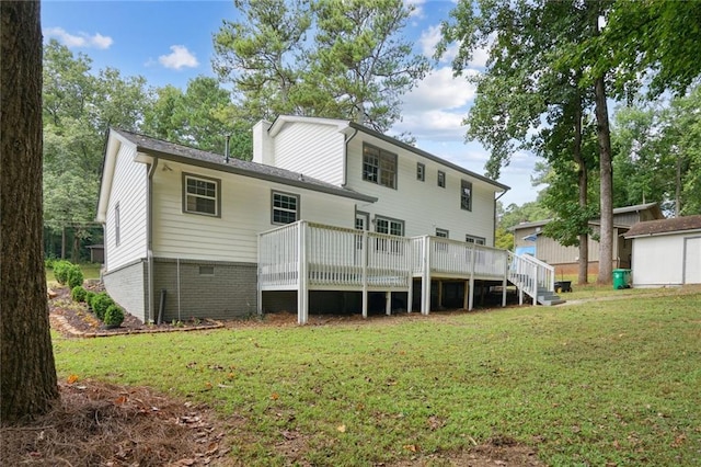 rear view of house featuring a deck and a lawn