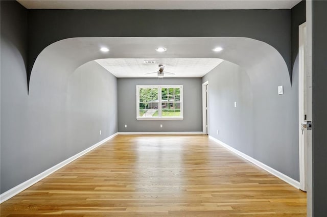 unfurnished room with light wood-type flooring and ceiling fan