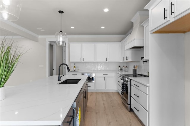 kitchen with light stone countertops, sink, pendant lighting, electric range, and white cabinets