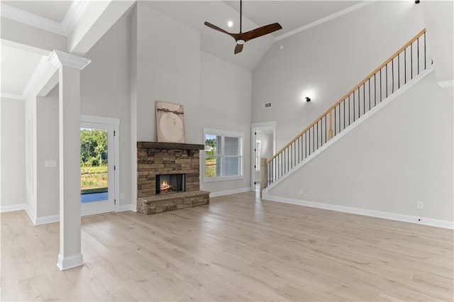 unfurnished living room featuring a wealth of natural light, light hardwood / wood-style flooring, and high vaulted ceiling