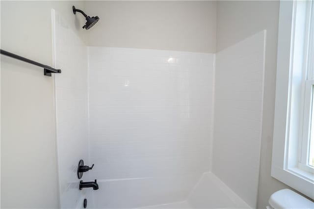 bathroom featuring toilet and bathtub / shower combination