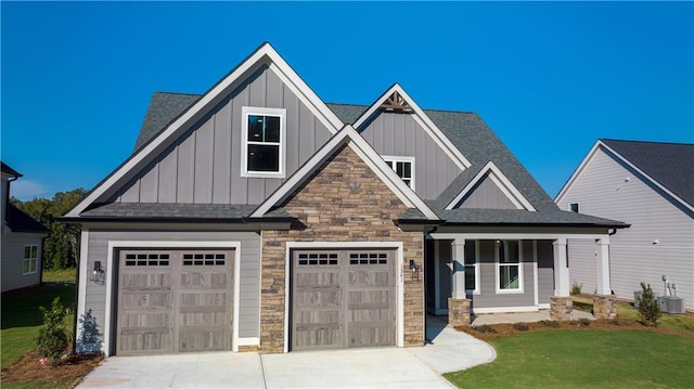 craftsman-style house featuring central air condition unit and a front lawn