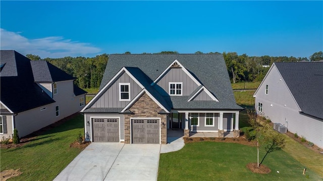 view of front of home with central AC and a front lawn