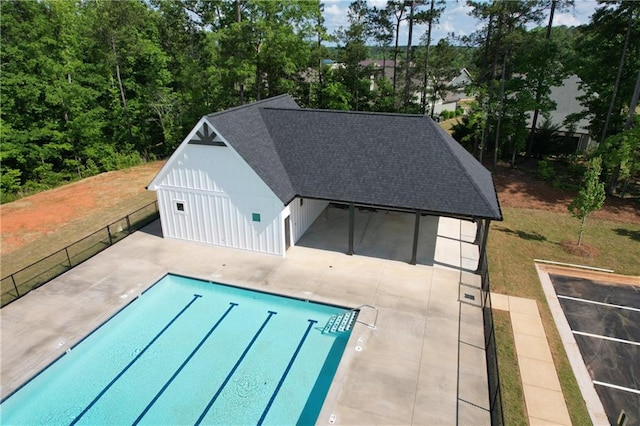 view of swimming pool featuring a patio area and an outdoor structure