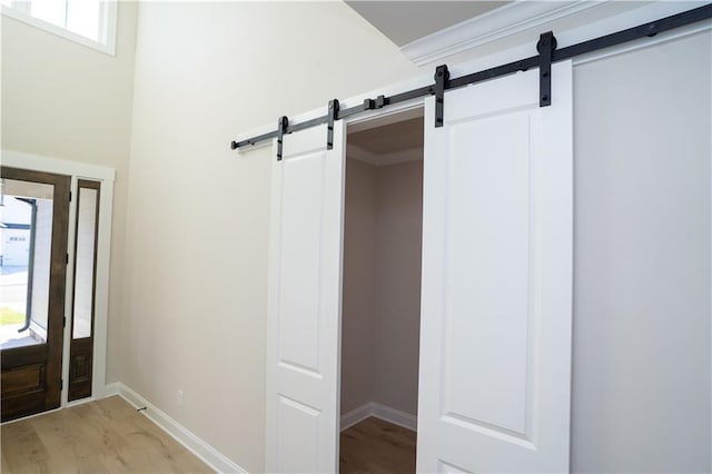 interior space with hardwood / wood-style flooring and crown molding