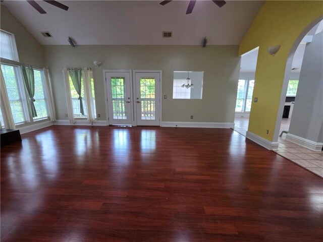 200 Valley Brook Dr, Newnan, GA 30265 - unfurnished living room with a ceiling fan, high vaulted ceiling, arched walkways, wood finished floors, and baseboards