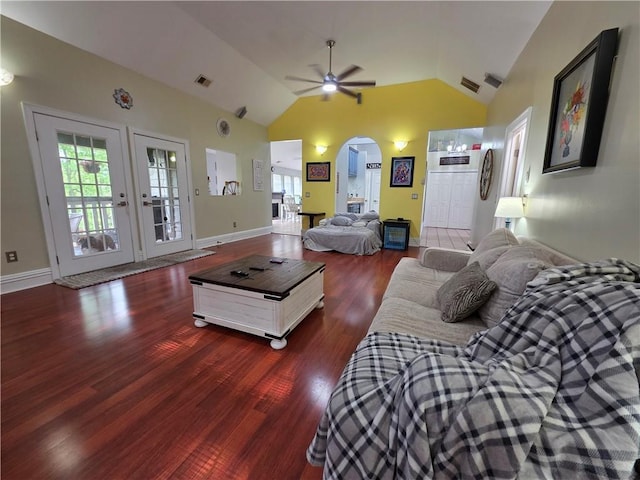 living room featuring ceiling fan, lofted ceiling, visible vents, arched walkways, and wood finished floors