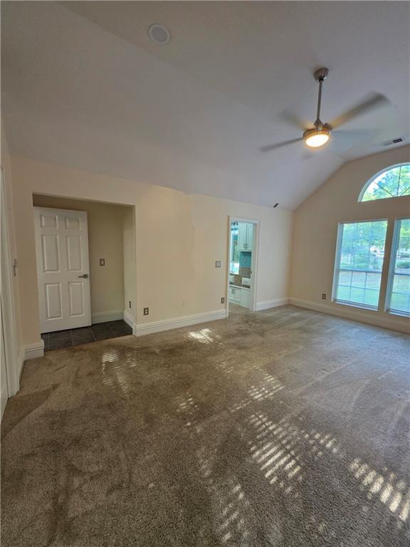 200 Valley Brook Dr, Newnan, GA 30265 - unfurnished living room with a ceiling fan, carpet, lofted ceiling, and baseboards