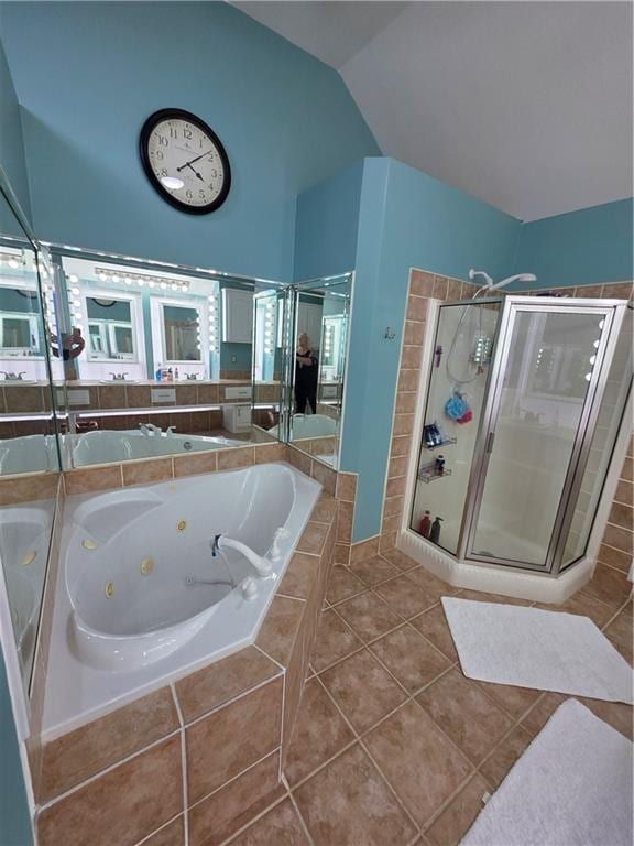 full bath with vanity, a stall shower, a tub with jets, tile patterned flooring, and lofted ceiling