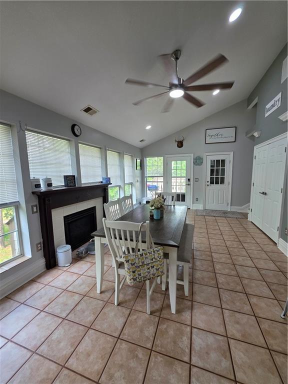 dining space with recessed lighting, light tile patterned floors, a ceiling fan, visible vents, and vaulted ceiling