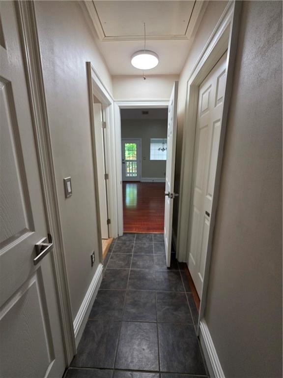 200 Valley Brook Dr, Newnan, GA 30265 - hall with attic access, baseboards, and dark tile patterned floors