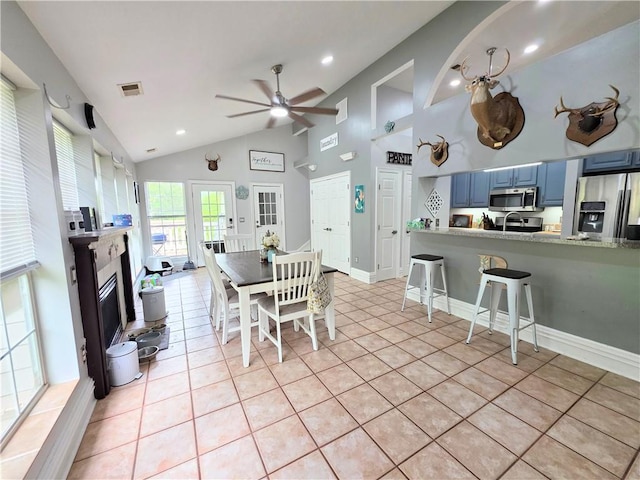 dining space featuring recessed lighting, ceiling fan, a glass covered fireplace, visible vents, and light tile patterned flooring