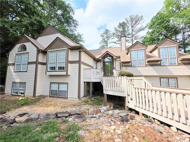 view of front facade featuring a deck and a chimney