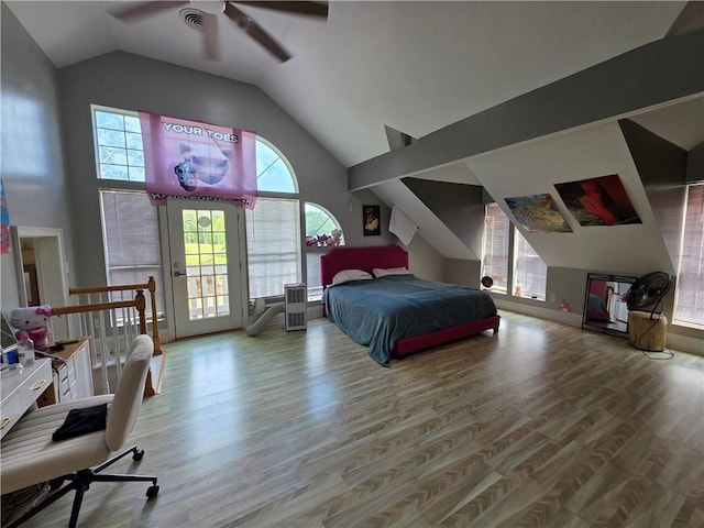 bedroom featuring lofted ceiling, wood finished floors, a ceiling fan, and access to outside