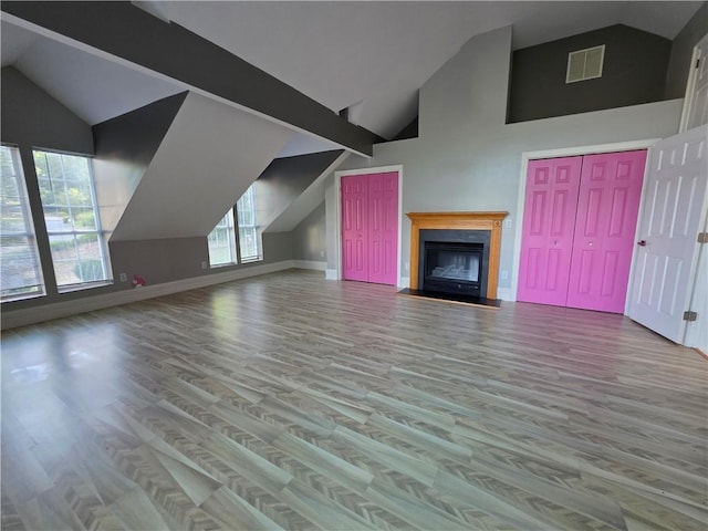 200 Valley Brook Dr, Newnan, GA 30265 - additional living space with high vaulted ceiling, wood finished floors, baseboards, and a fireplace with flush hearth