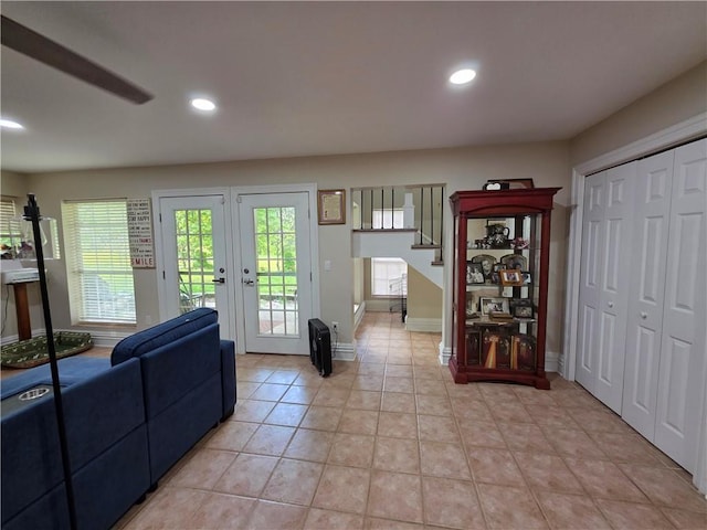 interior space with light tile patterned floors, baseboards, recessed lighting, french doors, and stairs