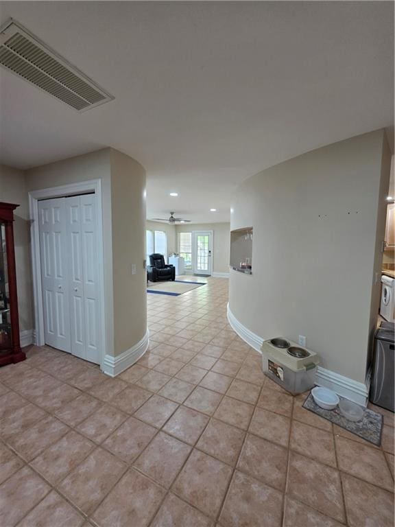 corridor with baseboards, visible vents, light tile patterned flooring, and recessed lighting