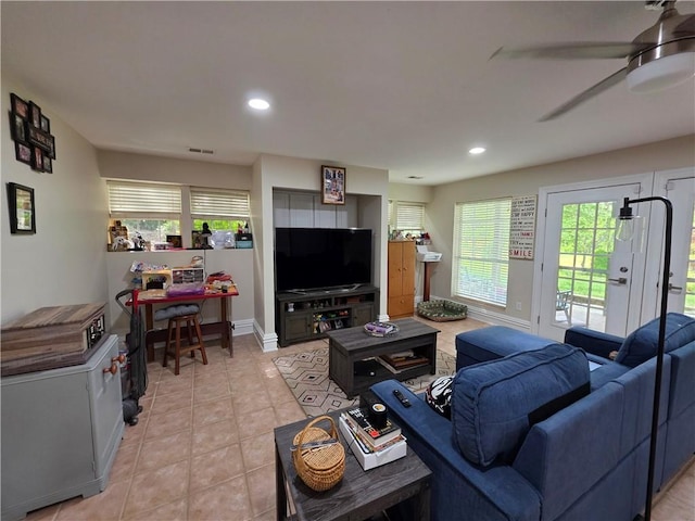 living area with light tile patterned floors, recessed lighting, a ceiling fan, and baseboards