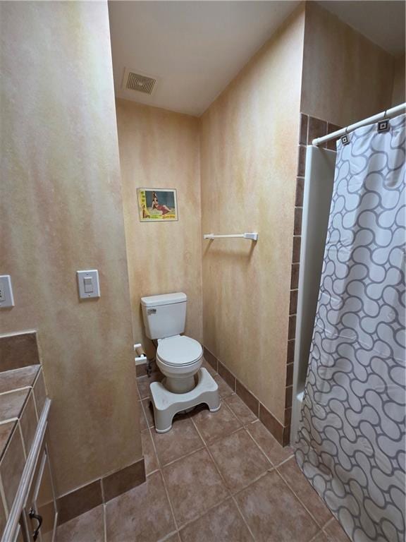 bathroom with visible vents, toilet, and tile patterned flooring