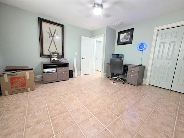 office area with baseboards, visible vents, light tile patterned floors, and ceiling fan