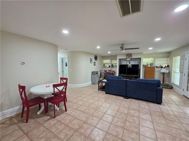 living room featuring a healthy amount of sunlight, visible vents, a ceiling fan, and recessed lighting